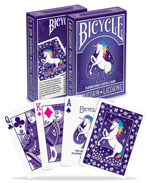 Playing cards' back design features a unicorn against a blueish-purple background resembling night time; flower patterns are scattered throughout. 