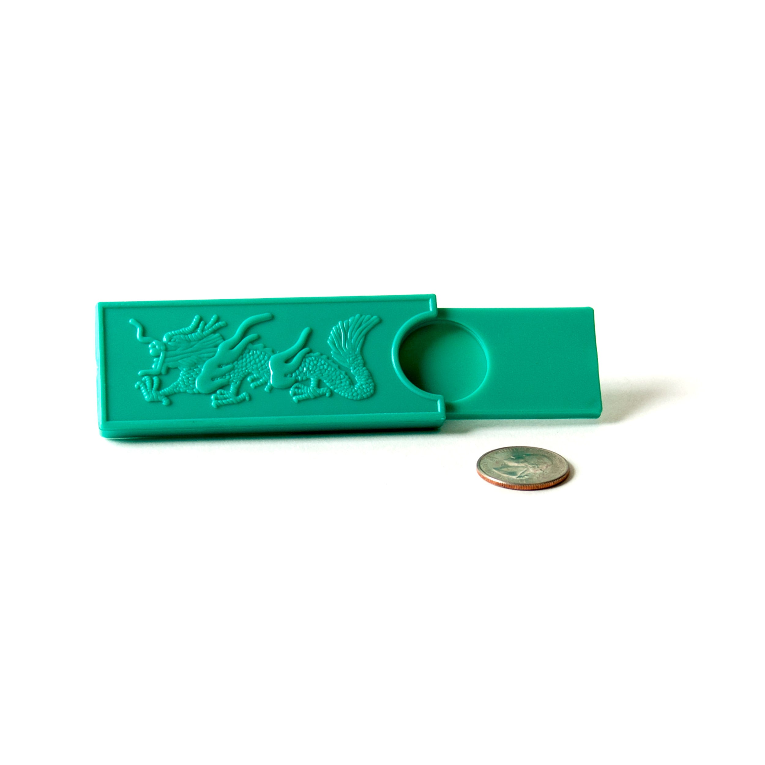 4" x 2" teal plastic case with a dragon design. Two shelves allow you to hide the coin within the case.