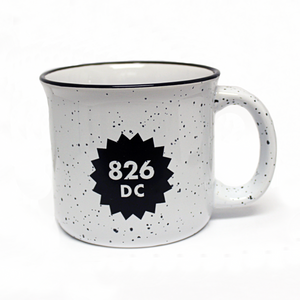 Large white speckled mug with a black rim and a black 826DC logo