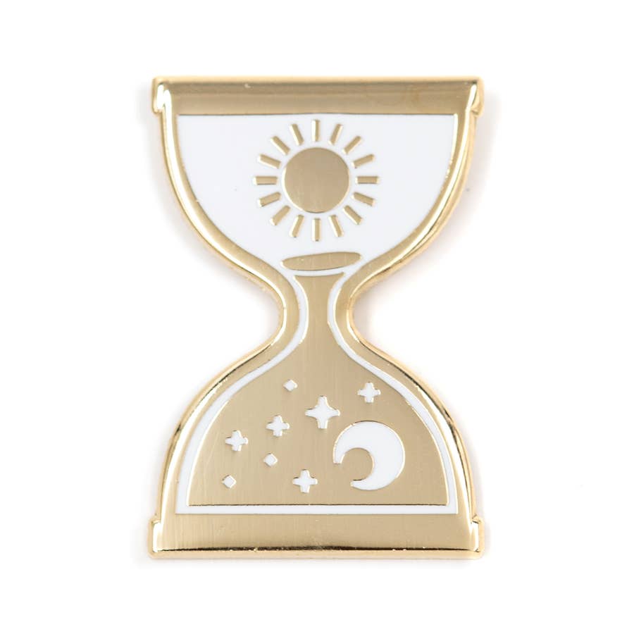 2 inch metallic gold pin in an hourglass shape. 1 inch rubber enclosure. Gold sun design against white background on top. White moon and stars design on the bottom half against a gold background.